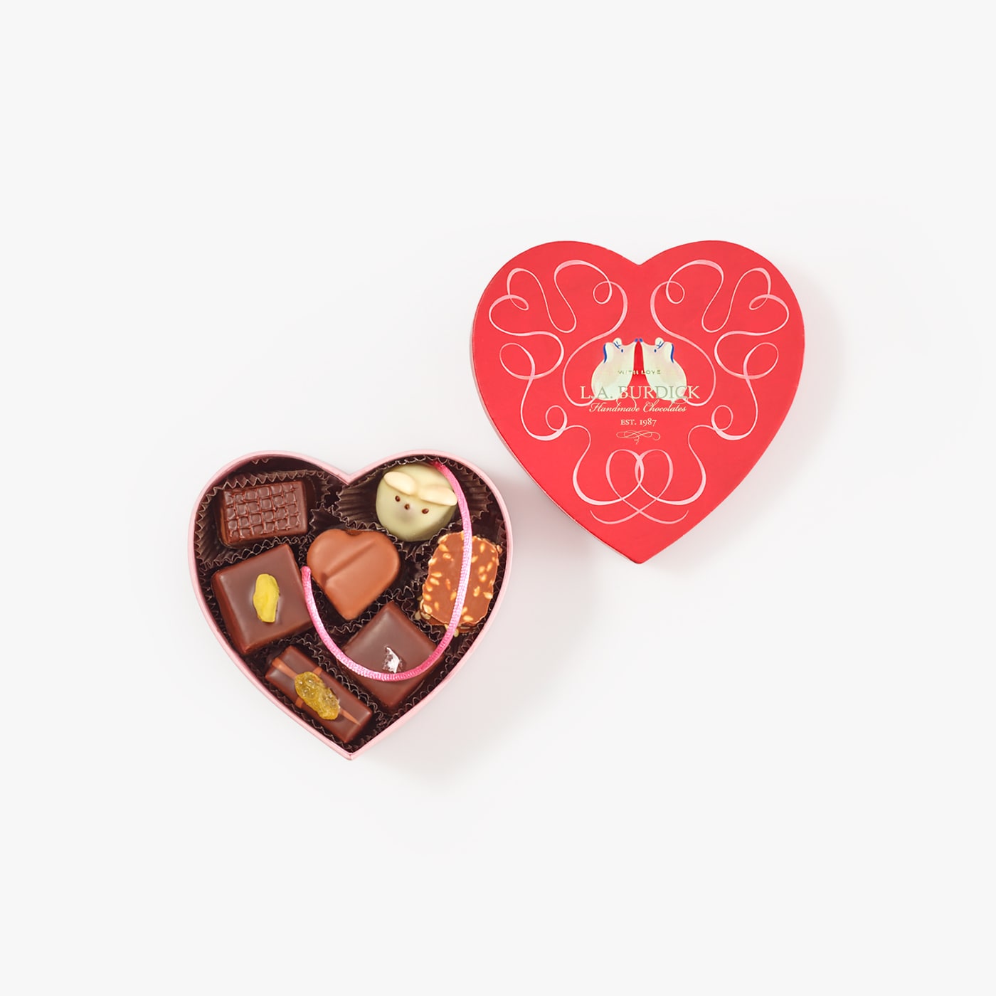 Handcrafted chocolates nestled inside a heart-shaped box with Valentine's Day illustration.